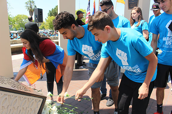 Students place flowers in memory of victims of the Armenian Genocide