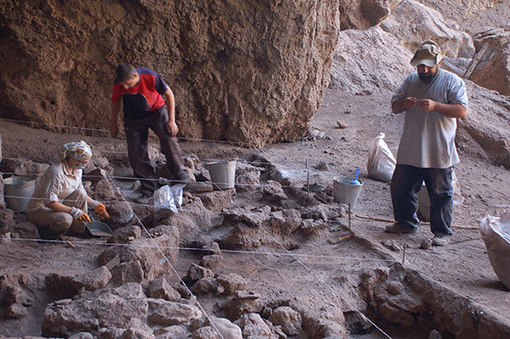 Kristine Martirosyan-Olshansky (far left) and Boris Gasparyan (far right) excavating the Areni-1 site, Armenia. (Photo: Gregory Areshian)