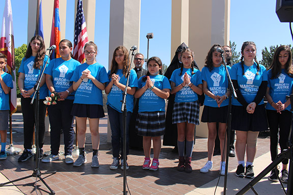 Students from each school led the opening prayer before ceremony began