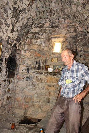 Inside the Soorp Pokas church with guide, showing well below the altar (Photo: Hovsep Dagdigian)