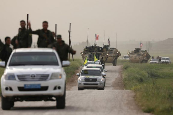 Kurdish fighters from the People's Protection Units (YPG) head a convoy of U.S military vehicles in the town of Darbasiya next to the Turkish border, Syria April 28, 2017. (Photo: Reuters/Rodi Said)