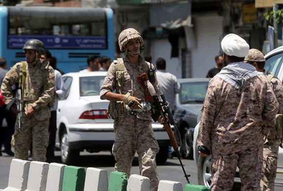 Iran's Revolutionary Guards protect the perimeter of the parliament after attack