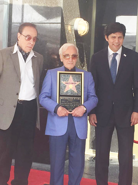 The legendary Charles Aznavour with his star on the Hollywood Walk of Fame is flanked by California Senate Pro Tem Kevin de Leaon (right) and director Peter Bagdanovich