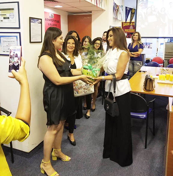 AMIDEAST students present Najwa Karam with a small cedar tree to thank her for her support.