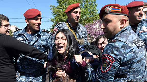 A protester on Monday is being dragged by Armenian police during a clash between law enforcement and protesters