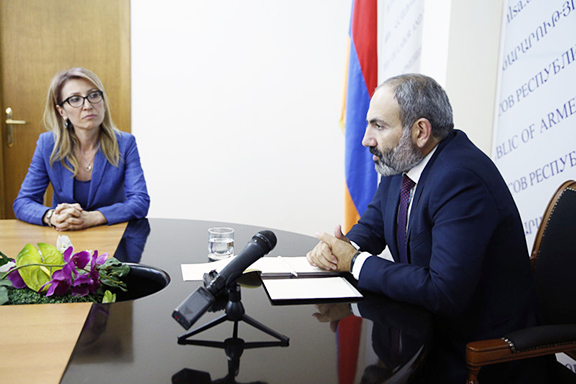 Armenia's Social Welfare Minister Mane Tandilyan (left) resigned Tuesday over the government decision to move forward with a controversial pension system