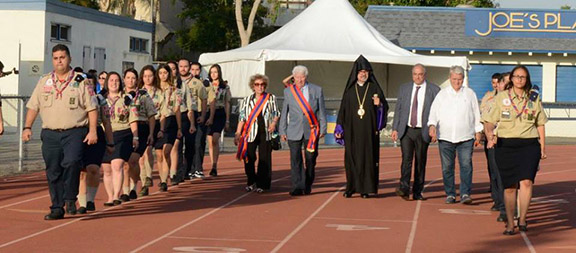 Navasartian Honorary President Mr. and Mrs Hamlet and Greta Chraghchian are joined by Prelate Moushegh Mardirossian and 2018 Exemplary Homenetmen member Koko Balian to kick off the parade of athletes and scouts