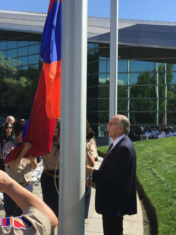 Fresno May Lee Brand at flag pole assits in the raising of the Armenian flag