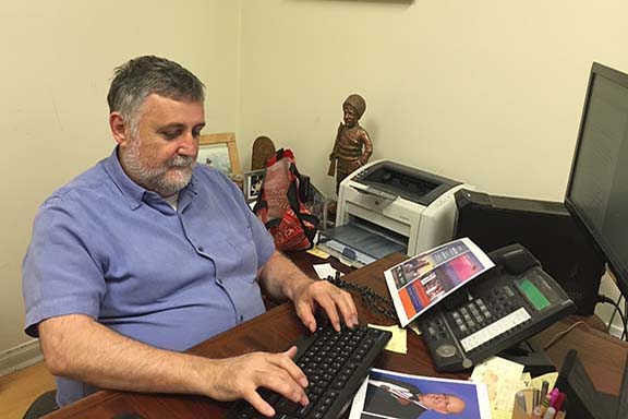 Apo Boghigian at his desk in Asbarez