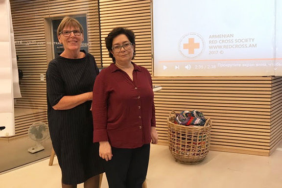 Susanna Haritunyan (right) with a representative of the Danish Red Cross