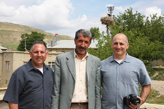 A half-Armenian man flanked by, cousins, George Aghjayan and Steve Mesrobian in Oozoonova, Palou, their grandmother’s village