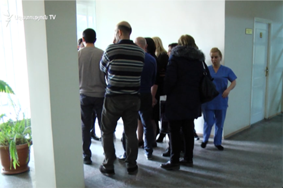 Staff of Armenia's HIV/AIDS clinic staff members stage walk out