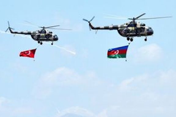 Military helicopters bearing the flags of Turkey and Azerbaijan in flight at the kickoff of joint military drills on July 29 