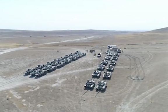 Turkish and Azerbaijan tanks and armored vehicles line a field in Azerbaijan on July 30