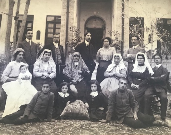 The family of the author's grandfather, pictured standing in the far left, with his wife holding a newborn